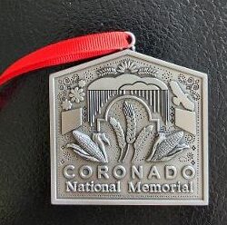 A metal ornament with the words Coronado National Memorial.
