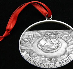 Horseshoe bend locket with a design n it