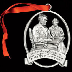 A medal with two person model and a ribbon