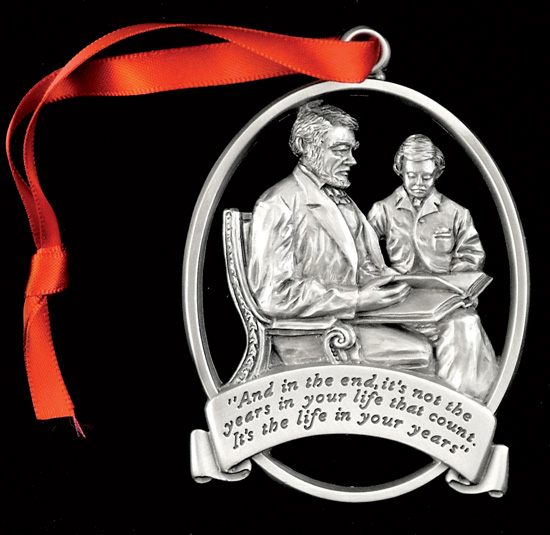 A medal with two person model and a ribbon