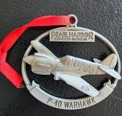 A silver ornament of a P-40 Warhawk airplane.