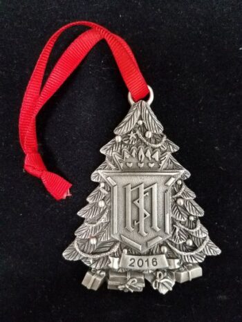 A Christmas shaped medal with a ribbon