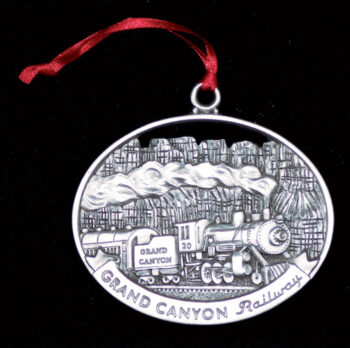 Pewter ornament of a train in the Grand Canyon.