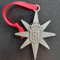 A star shaped medal with a red ribbon