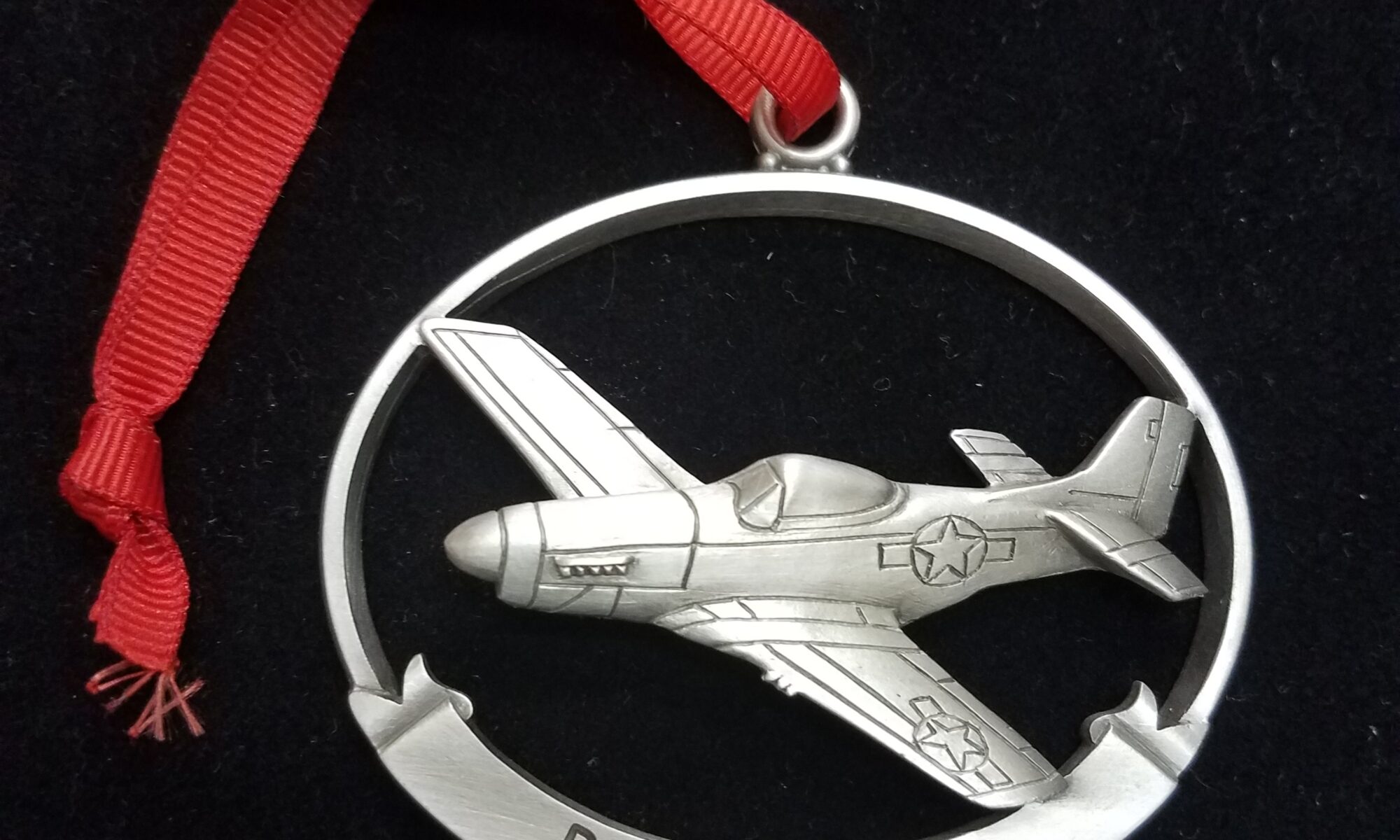 P 51 mustang medal with a red ribbon