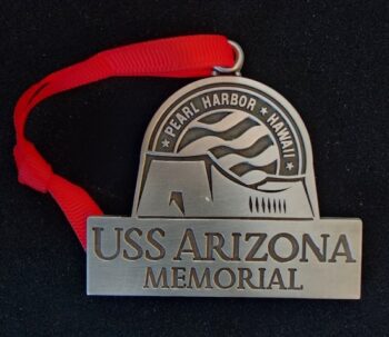 A metal USS Arizona Memorial ornament.