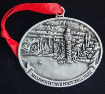 A silver ornament with the words mammoth cave national park on it.